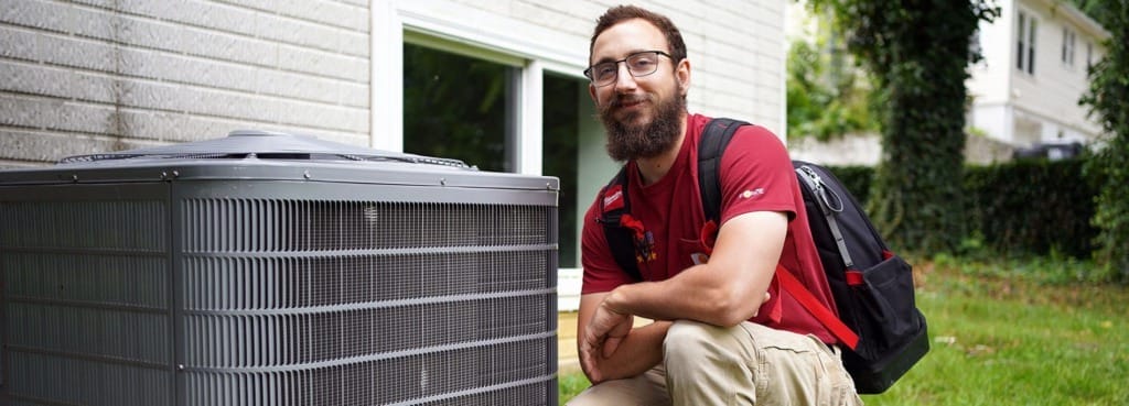 tech next to ac unit