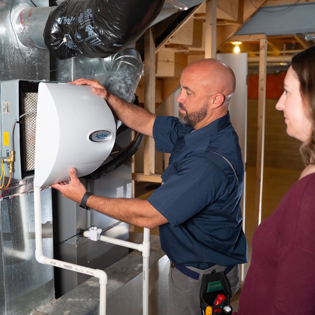 Humidifiers | Five Star Home Services hvac tech showing a homeowner their humidifier