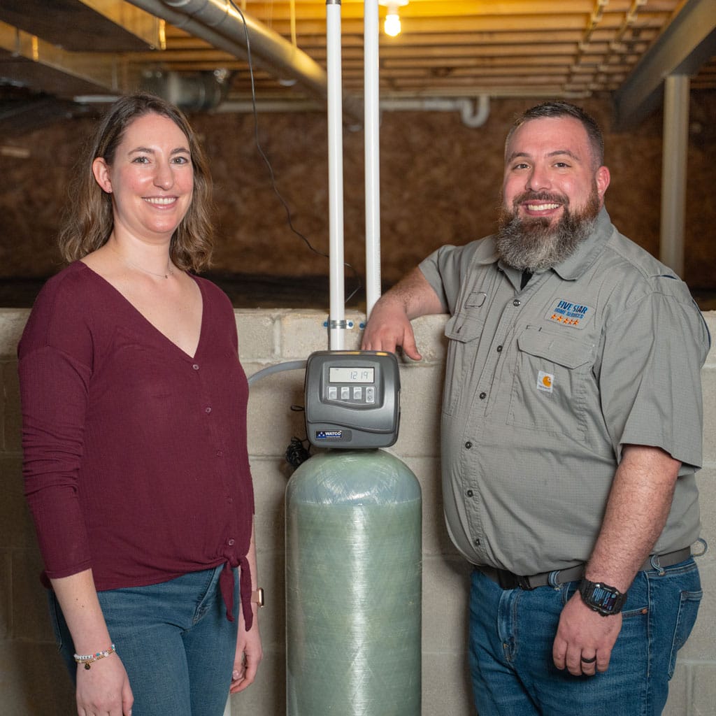 Jordan Posner of @midwest_foodfest with a Five Star Home Services technician after a carbon filter installation in her home basement.