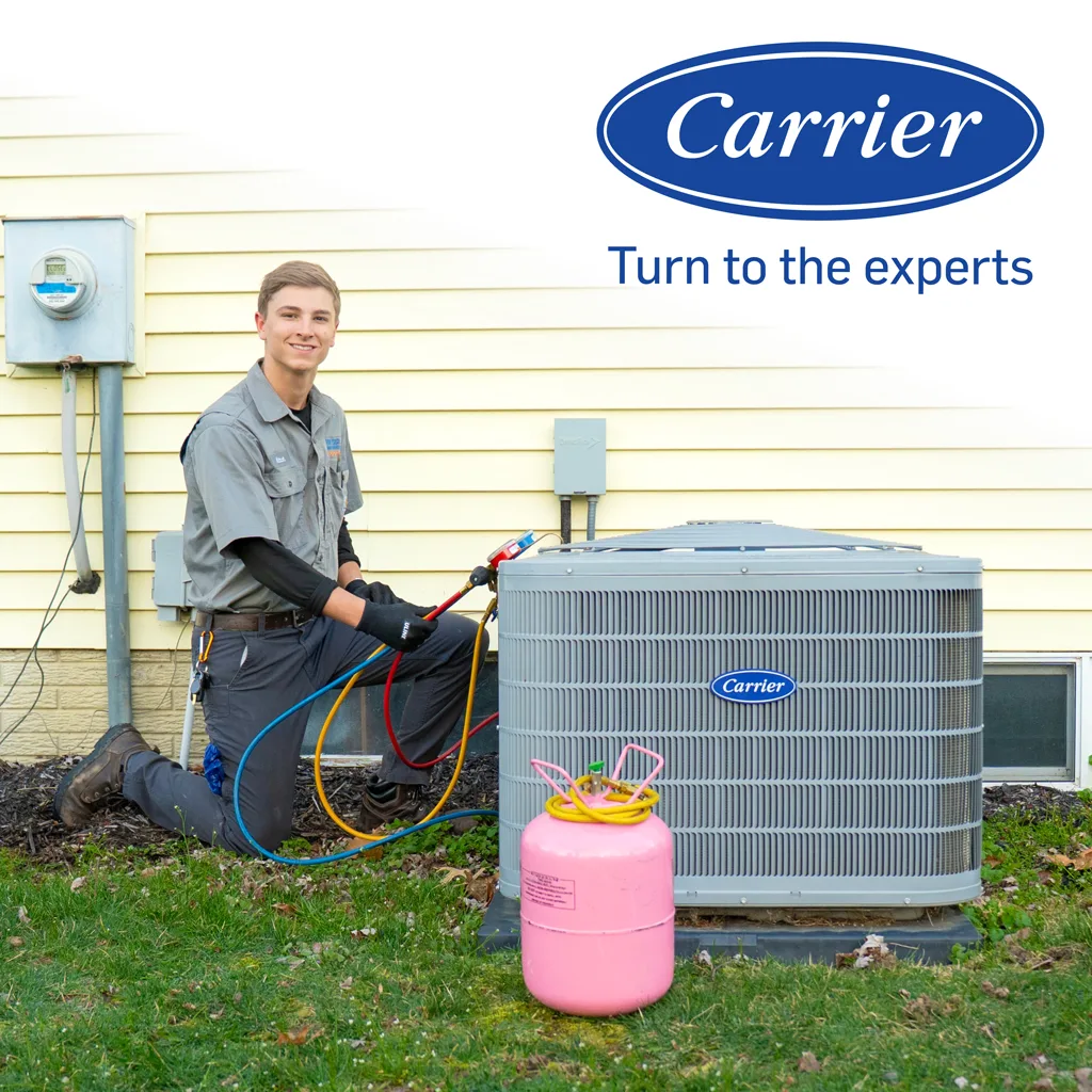 Technician next to Carrier AC