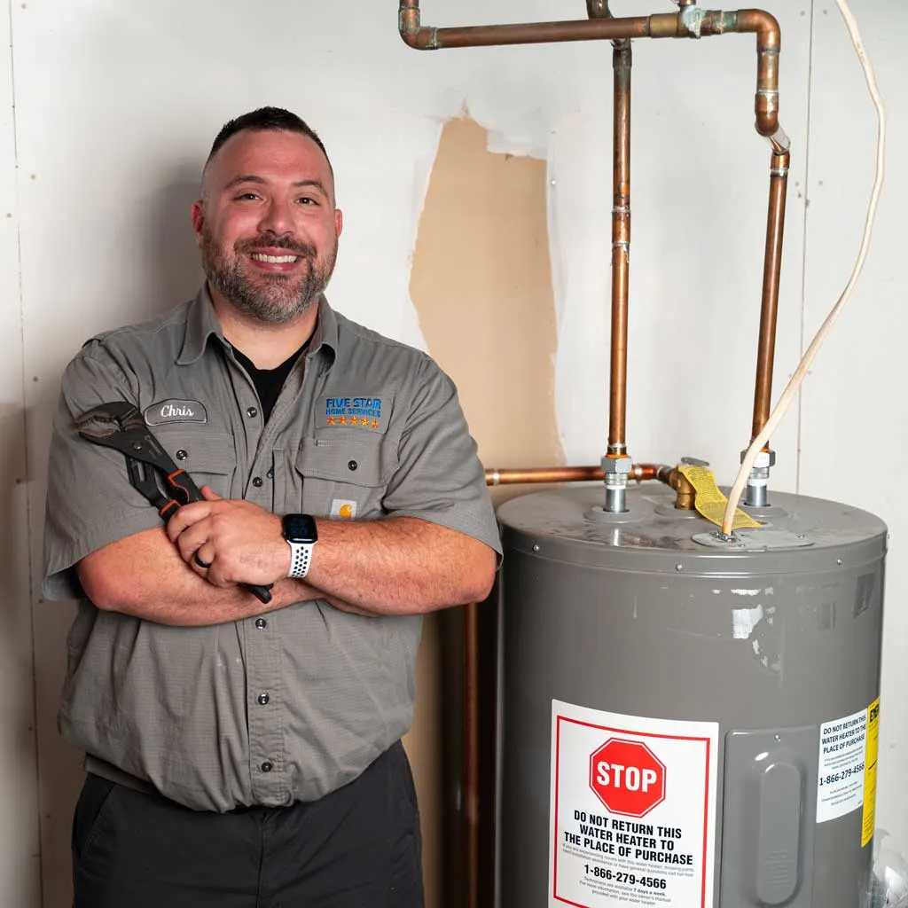 tech standing next to water heater
